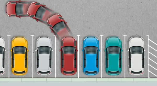 Schemat pokazuje, jak parkować prostopadle. Czerwony samochód wykonuje manewr cofania, by zająć miejsce parkingowe.